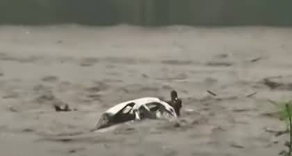 Exclusive Video: A Man rescued from car swept into river as Typhoon Doksuri hits China