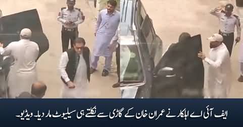 FIA security personnel salutes Imran Khan as he comes out of his car