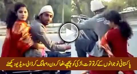 Pakistani Boy Performing One Wheeling with A Girl Sitting on Bike