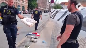 Police in Denmark hand Koran back to book burners after a protester snatch it